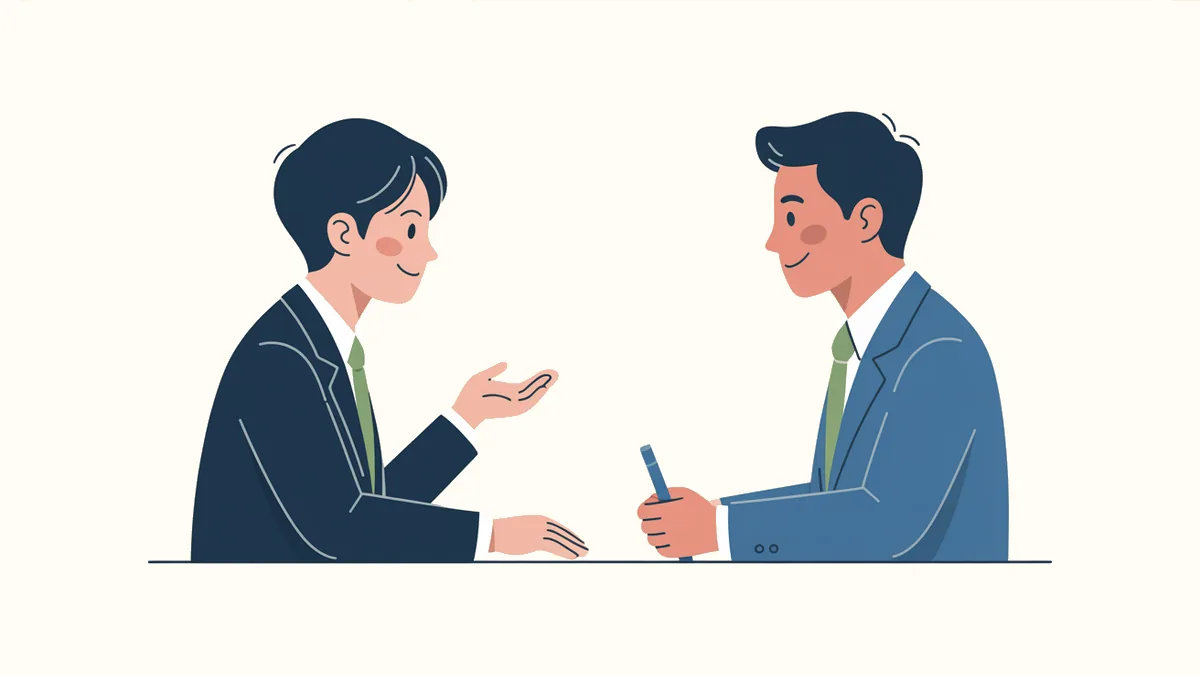 机をはさんで学生と面接官が向かい合い、学生が手ぶりを交えて話し、面接官がペンを手に聞いているイラスト